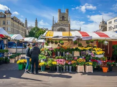 two people standing in front of a market with flowers at City Studio - very best Location For exploring Cambridge - walk to station and City Centre in Cambridge