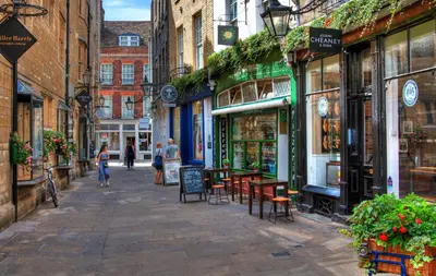a street in a city with people walking down it at Luxury City CB1 Studio Just Off Mill Rd - Walk to Station and City Centre in Cambridge