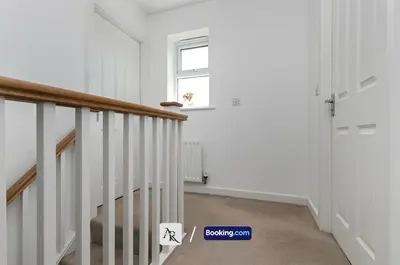 a room with a staircase and a window at Stylish House By AR Properties Short Lets & Serviced Accommodation Colchester in Colchester