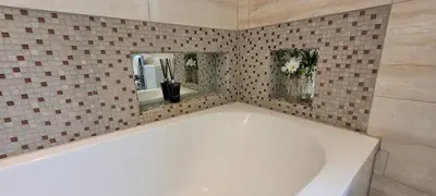 a white bath tub in a tiled bathroom at Loughton 3 Bedroom Sleeps 5 by BSE Homes in Loughton