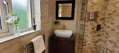 a bathroom with a sink and a mirror and a window at Loughton 3 Bedroom Sleeps 5 by BSE Homes in Loughton