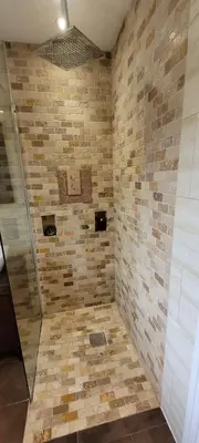 a bathroom with a shower with a tiled wall at Loughton 3 Bedroom Sleeps 5 by BSE Homes in Loughton