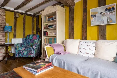 a living room with a couch and a chair at Pats Place in Sudbury