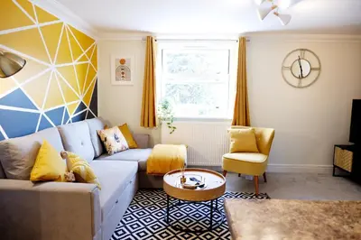 a living room with a couch and a table at Modern 2-Bed Duplex - 10 Mins to City Centre in Chesterton