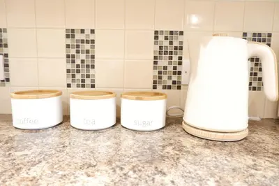 a group of three coffee jars on a counter in a kitchen at Modern 2-Bed Duplex - 10 Mins to City Centre in Chesterton