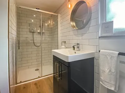 a bathroom with a sink and a shower at The Little Barn in Hoxne