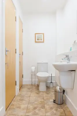 a bathroom with a toilet and a sink at Camstay Longworth Avenue in Cambridge