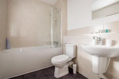 a bathroom with a toilet and a sink and a shower at Camstay Longworth Avenue in Cambridge