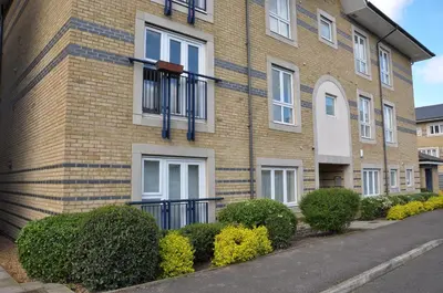 a brick building with bushes in front of it at Camstay Longworth Avenue in Cambridge