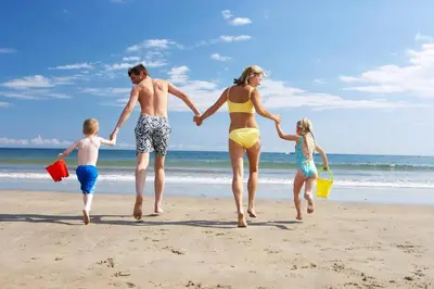 a family running on the beach at Lovely 6 Berth Caravan At Seawick Holiday Park In Essex Ref 27008S in Clacton-on-Sea