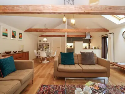 a living room with two couches and a table at The Cart Lodge at Grove Barn in Eye