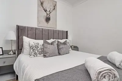 a bedroom with a white bed with pillows at Lavish Rayleigh Apartment - LMV Property in Rayleigh