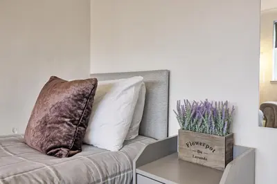 a pillow on a bed in a room at Lavish Rayleigh Apartment - LMV Property in Rayleigh