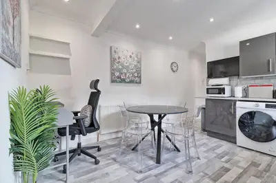 a kitchen and dining room with a table and chairs at Lavish Rayleigh Apartment - LMV Property in Rayleigh