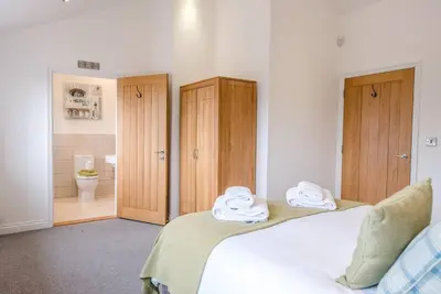 a bedroom with two beds with towels on them at Foxglove House, Aldeburgh in Aldeburgh