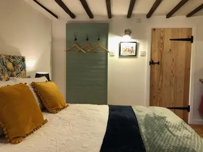 a bedroom with a bed with yellow pillows on it at Sunrise Studio in Colchester