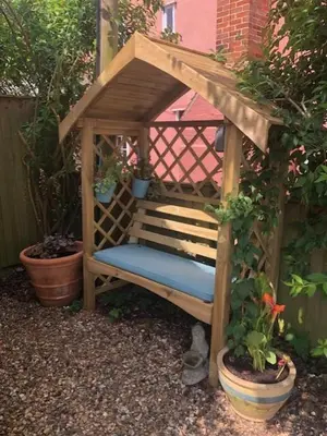 a wooden chair in a gazebo with plants at Sunrise Studio in Colchester