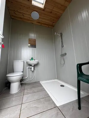 a bathroom with a toilet and a sink at Henny Riverside Glamping in Sudbury