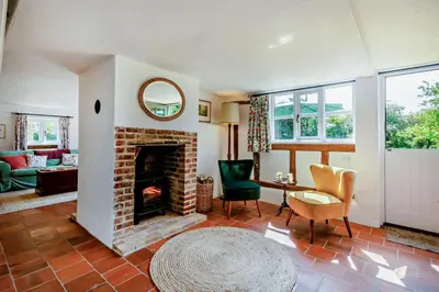 a living room with a fireplace and a table and chairs at 2 Bed in Ilketshall St. Margaret oc-w27520 in Rumburgh