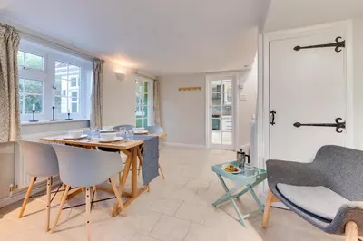 a living room with a dining room table and chairs at 2 Bed in Sweffling oc-whcs in Rendham
