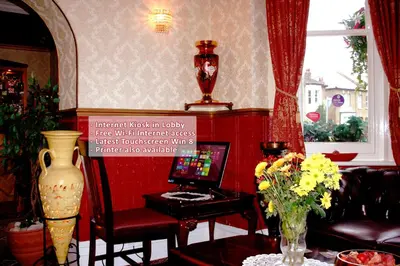 a living room with a vase of flowers on a table at Ilfracombe House Hotel - near Cliffs Pavilion in Southend-on-Sea