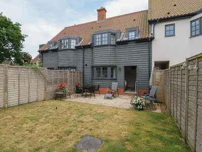 a backyard of a house with a fence at 9 Oaks Court in Leiston