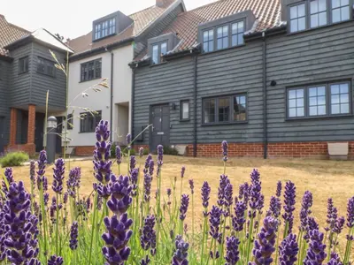 a house with purple flowers in front of it at 9 Oaks Court in Leiston