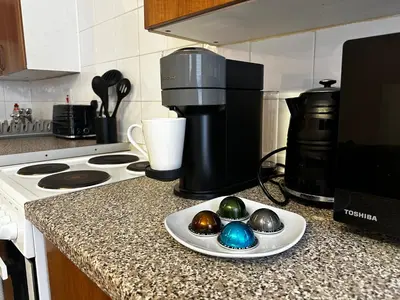 a kitchen counter with a plate with three eggs on it at Entire Apartment boutique king size bed near Town Centre in Colchester