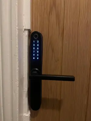 a remote control attached to a wooden door at Entire Apartment boutique king size bed near Town Centre in Colchester