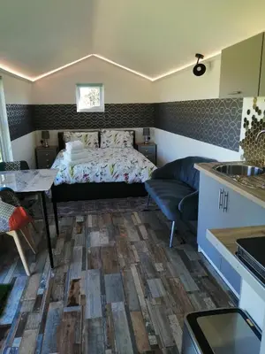 a small room with a bed and a table at The Cabin in Pakenham