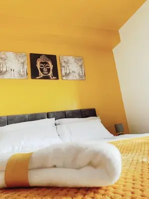 a persons hand laying on a bed in a bedroom at 2 Bed Apartment with Free Parking in Chelmsford
