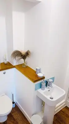a bathroom with a white toilet and a sink at 2 Bed Apartment with Free Parking in Chelmsford