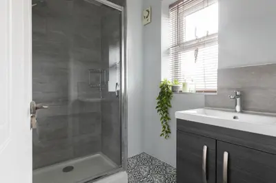 a bathroom with a shower and a sink at Chelmsford Reach 3 bed house near centre,free parking, Wi-Fi, table football in Chelmsford