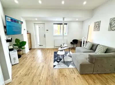 a living room with a couch and a table at The Modern Smart Home in Great Warley Street