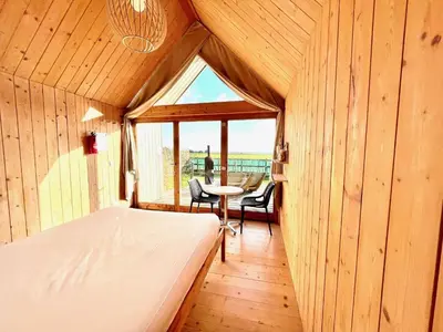 a bedroom with a bed and a table in a room at Lushna 12 Lux at Lee Wick Farm Cottages & Glamping in Clacton-on-Sea