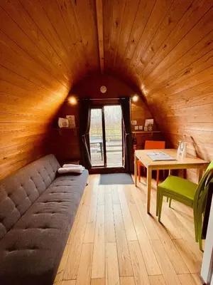 a room with a couch and a table in a room at MegaPod 3 at Lee Wick Farm Cottages & Glamping in Clacton-on-Sea