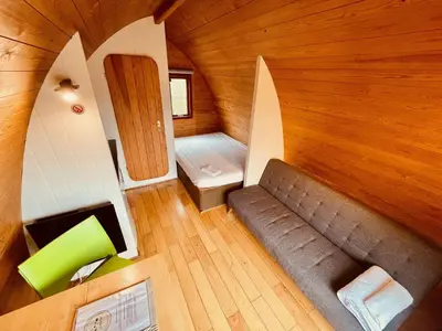 an overhead view of a room with a couch and a bed at MegaPod 2 at Lee Wick Farm Cottages & Glamping in Clacton-on-Sea