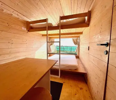a small room with a bunk bed and a desk at Lushna 3 Petite at Lee Wick Farm Cottages & Glamping in Clacton-on-Sea