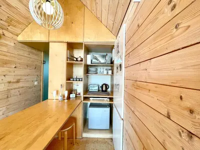 a kitchen with wooden walls and a wooden counter at Lushna 6 Petite at Lee Wick Farm Cottages & Glamping in Clacton-on-Sea