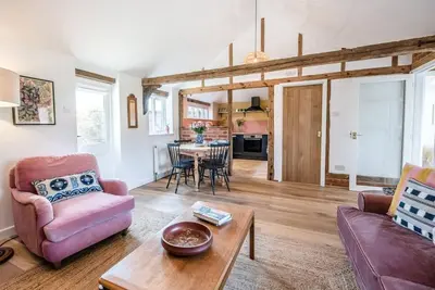 a living room with a couch and a table at The Stables, Hoo in Woodbridge