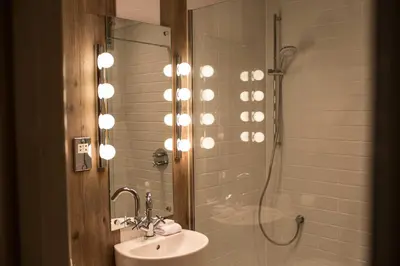 a bathroom with a shower and a sink and a shower at Milsoms in Dedham