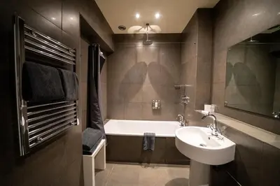 a bathroom with a sink and a bath tub at Milsoms in Dedham