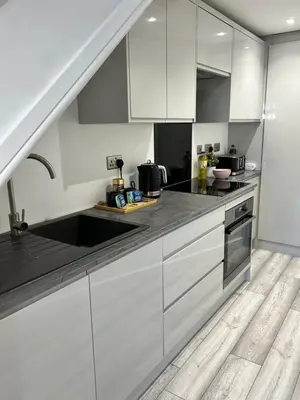 a kitchen with white cabinets and a sink at Luxury Retreat Beach House - Sleeps 6 in Southend-on-Sea