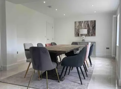 a dining room with a wooden table and chairs at Large Countryside House Swim Pool Jacuzzi Sleeps 10 guest in Ware