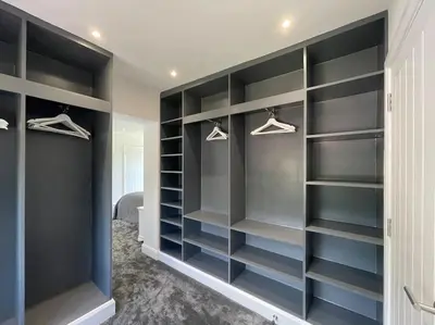 a walk in closet with black shelves at Large Countryside House Swim Pool Jacuzzi Sleeps 10 guest in Ware