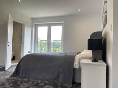 a white bedroom with a bed and a window at Large Countryside House Swim Pool Jacuzzi Sleeps 10 guest in Ware