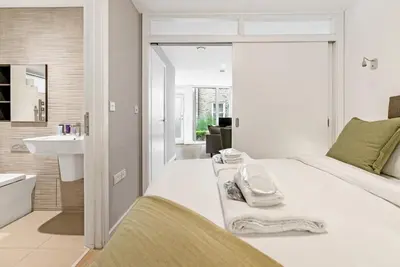 a bedroom with a white bed and a sink at Tailored Stays - Central Cambridge, River Walk Apartments in Cambridge