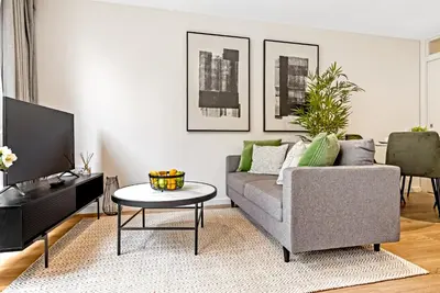 a living room with a couch and a table at Tailored Stays - Central Cambridge, River Walk Apartments in Cambridge