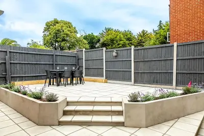 a patio with a fence and a table and chairs at Shore House - Walton in Walton-on-the-Naze