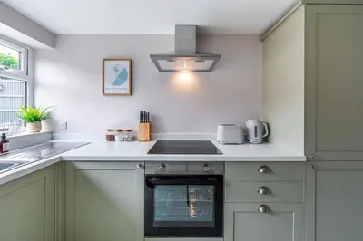 a kitchen with a sink and a stove top oven at Shore House - Walton in Walton-on-the-Naze